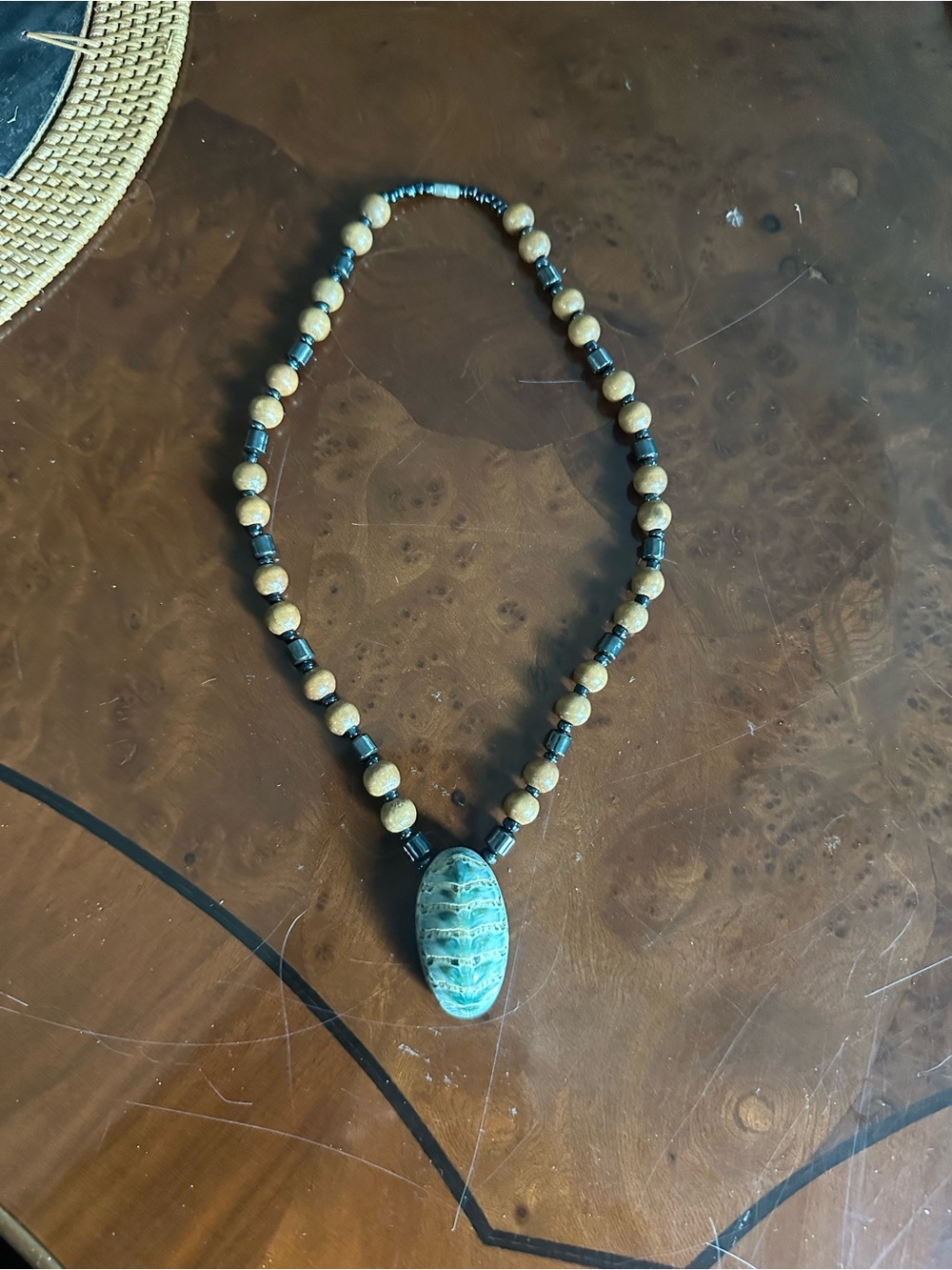 Hand crafted necklace featuring chiton marine mollusk shell pendant